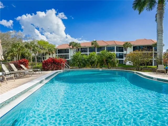 Community pool with a patio