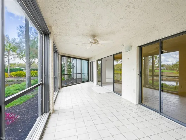 Unfurnished sunroom featuring ceiling fan and plenty of natural light