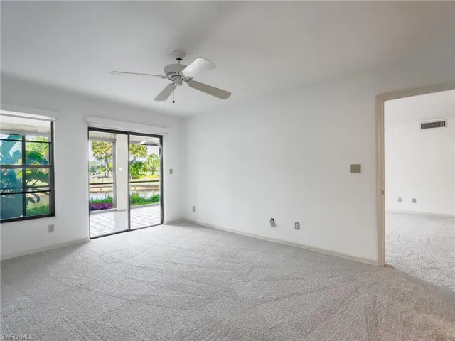 Empty room featuring ceiling fan and light colored carpet