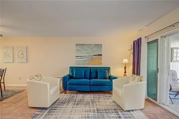 Living room with light tile patterned floors and baseboards