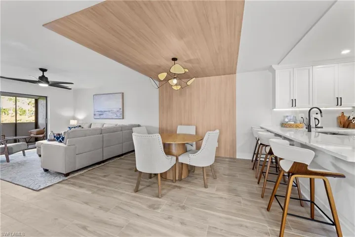 Dining space with wooden ceiling and wood tiled floors