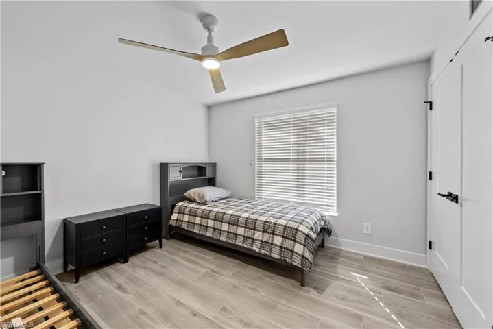Bedroom featuring wood tiled floors and ceiling fan