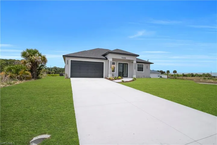 Contemporary single-story residence featuring a light gray exterior, a dark gray shingle roof, and a two-car garage with a dark gray door