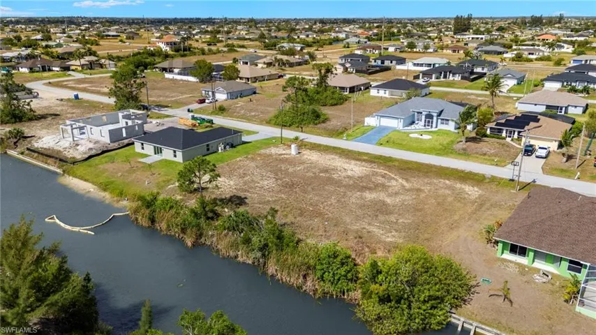 Aerial perspective of suburban area featuring a large body of water