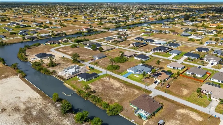 Aerial overview of property's location featuring nearby suburban area and a nearby body of water