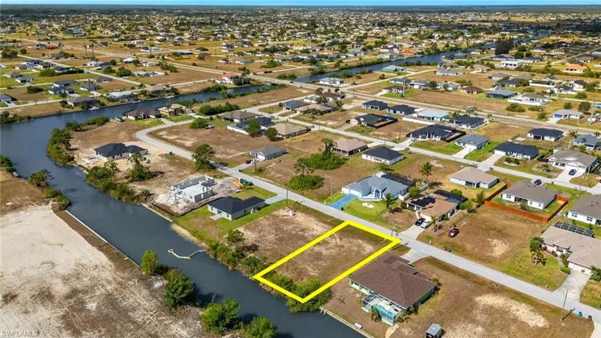 Aerial perspective of suburban area featuring a nearby body of water