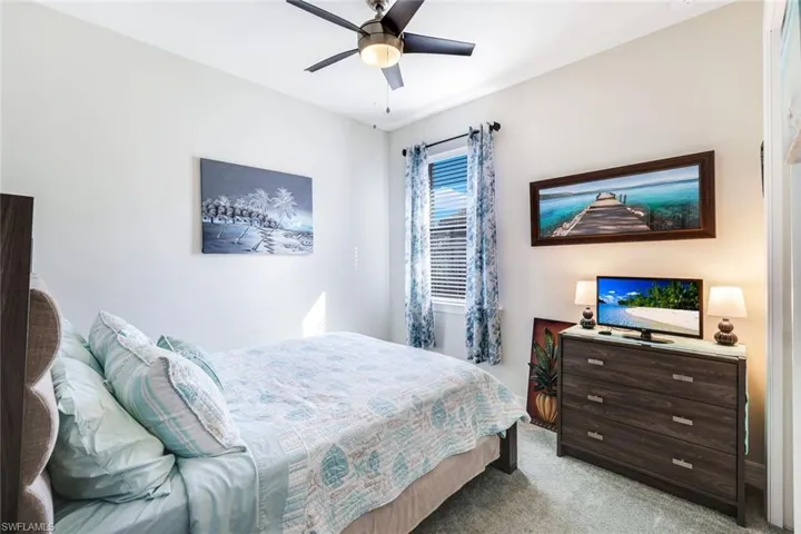 Bedroom featuring ceiling fan and light colored carpet
