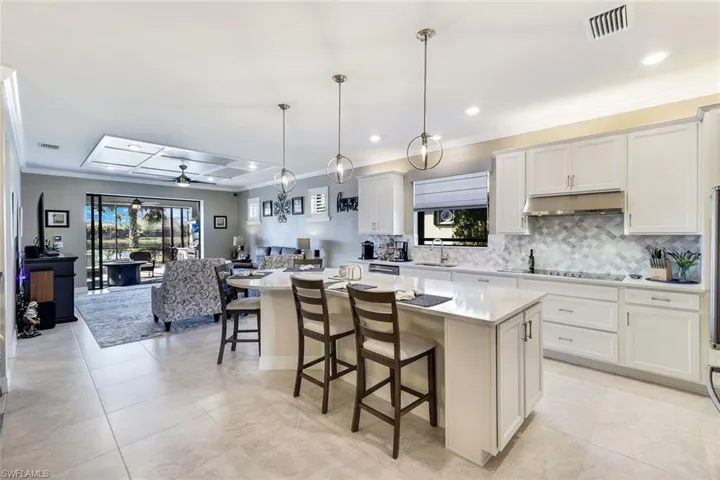 Kitchen featuring a center island, decorative light fixtures, and plenty of natural light