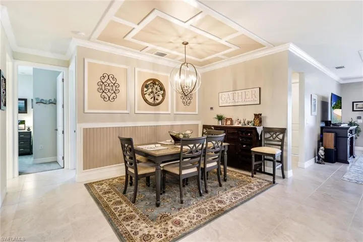 Dining space featuring crown molding and a notable chandelier