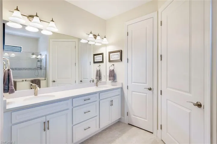 Bathroom featuring vanity and a tile shower