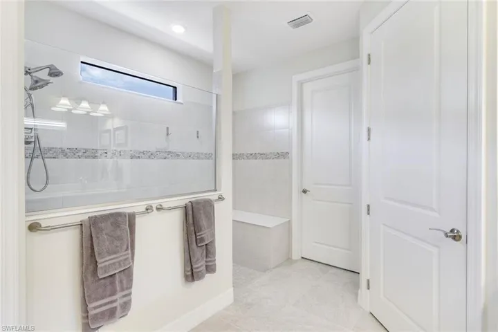 Bathroom featuring a tile shower and tile patterned floors