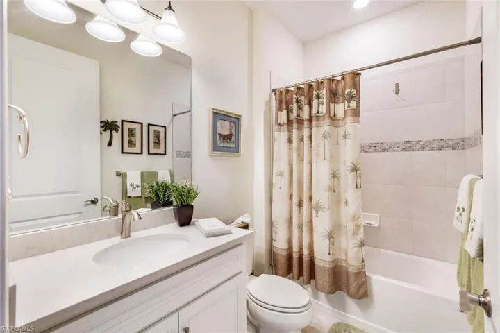 Full bathroom with vanity, toilet, and shower / tub combo