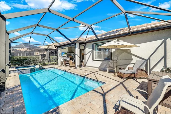 View of pool featuring a lanai, an in ground hot tub, and a patio