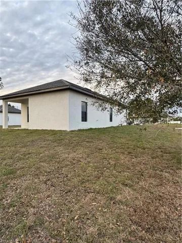 View of home's exterior with a yard