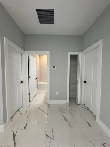 Unfurnished 1-2 guess  bedroom with connected bathroom and a closet
