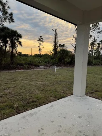 Yard at dusk with a patio area