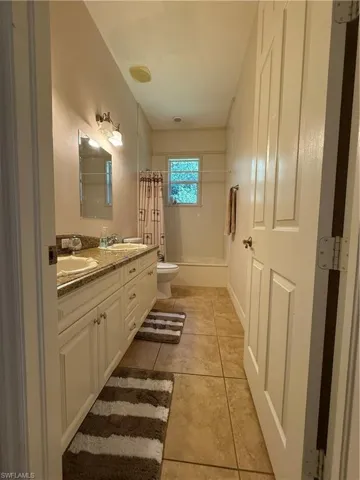 Hall featuring light tile patterned floors