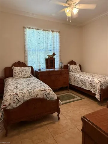 Tiled bedroom with ceiling fan