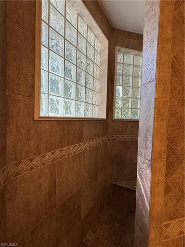 Bathroom featuring vanity, tile patterned floors, and ceiling fan