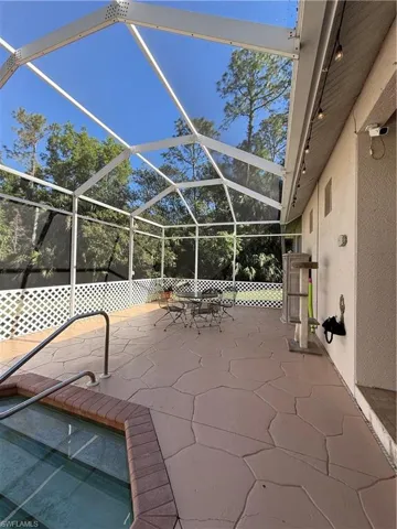 View of patio / terrace with an outdoor living space with a fireplace and ceiling fan