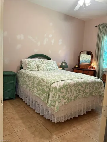Full bathroom with toilet, vanity, tile patterned floors, and shower / tub combo with curtain