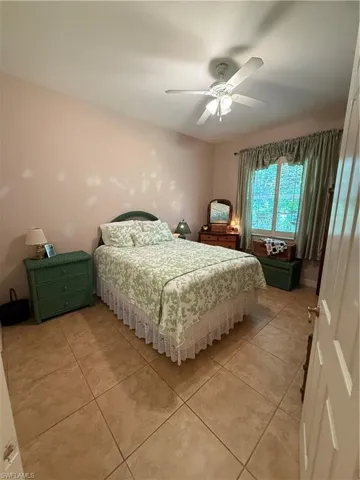 Full bathroom with toilet, shower / bath combo, vanity, and tile patterned floors