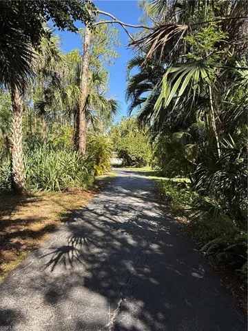 View of property's community with a yard