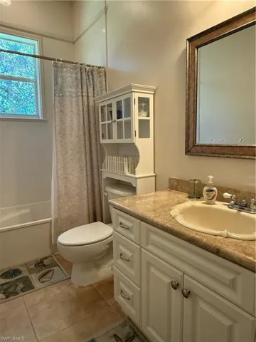 Sitting room with ceiling fan and light tile patterned floors