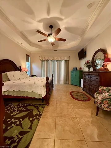 Bathroom featuring tile patterned flooring, vanity, and shower with separate bathtub