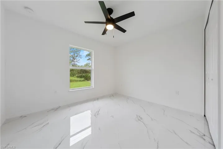 Spare room with ceiling fan