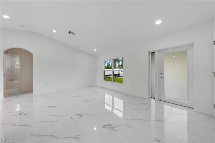 Unfurnished room with vaulted ceiling
