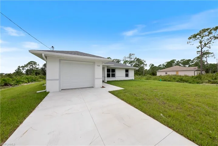 Single story home featuring a front lawn and a garage
