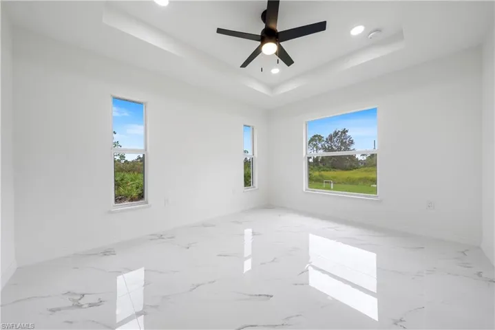 Spare room featuring ceiling fan and a raised ceiling