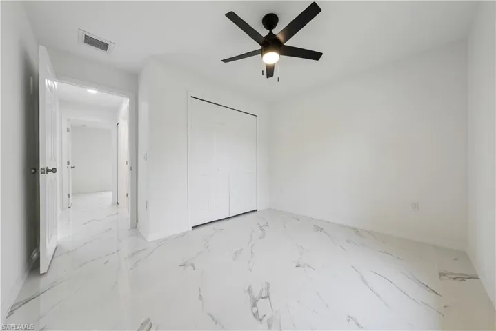 Unfurnished bedroom featuring a closet and ceiling fan