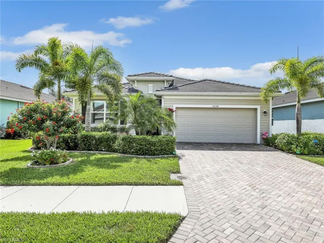 Beautifully landscaped with paver driveway!