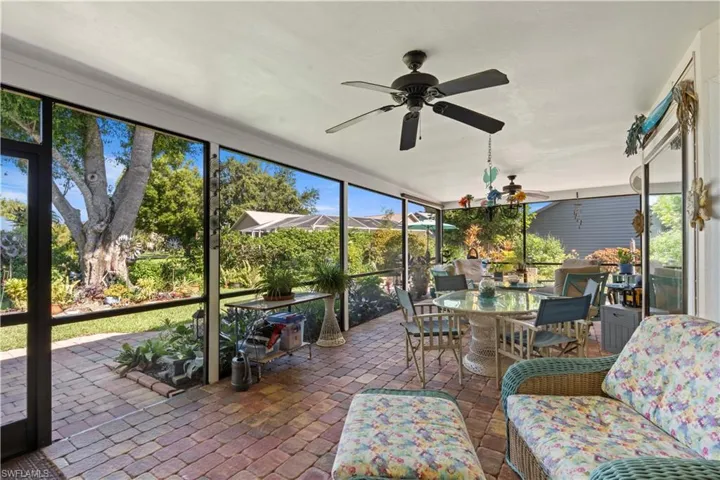 Sunroom featuring outdoor dining area and ceiling fan
