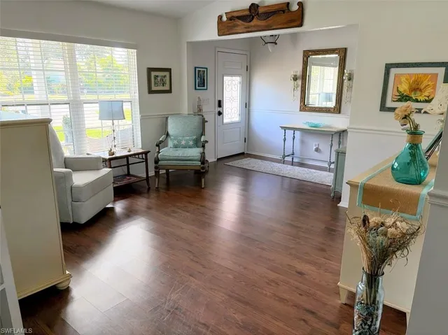 Sitting room with dark wood-style floors and baseboards