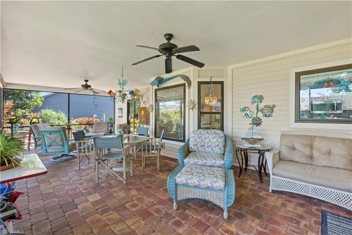 View of patio with a ceiling fan and outdoor dining area