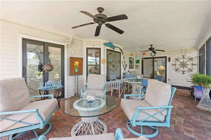 View of patio with outdoor dining space and ceiling fan