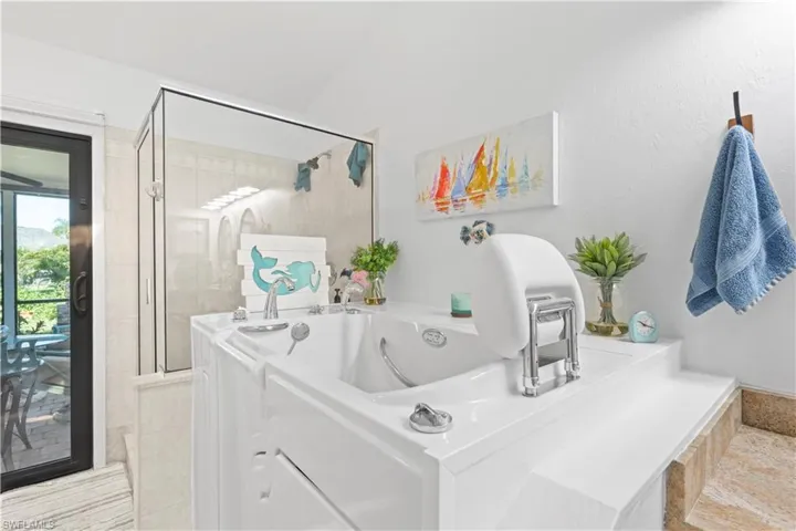 Bathroom with a whirlpool tub and tiled shower