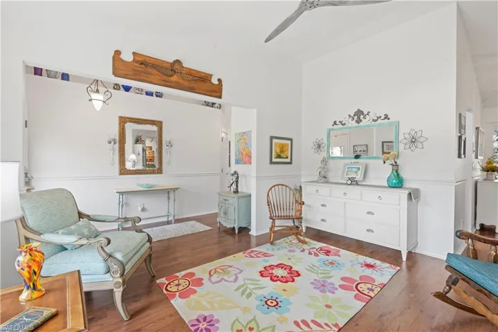 Living area featuring wood finished floors and ceiling fan