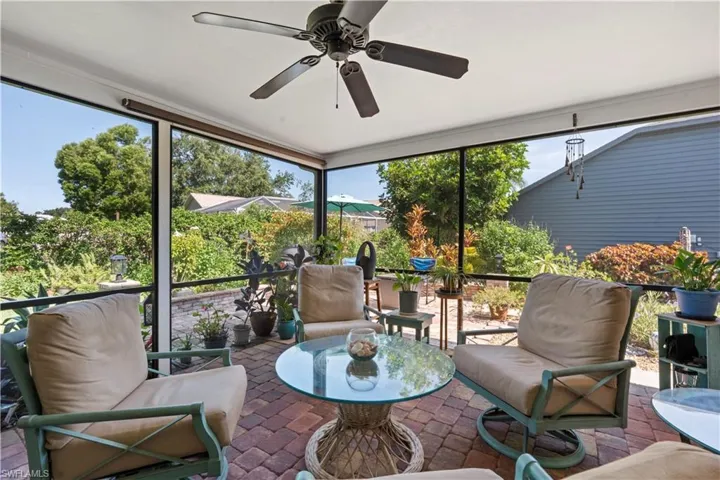 Sunroom / solarium featuring ceiling fan