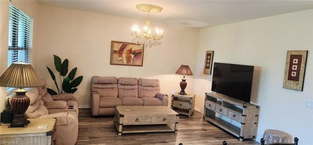 Living room with wood finished floors and a chandelier