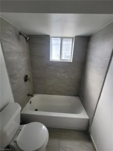 Bathroom with toilet and shower / bathtub combination