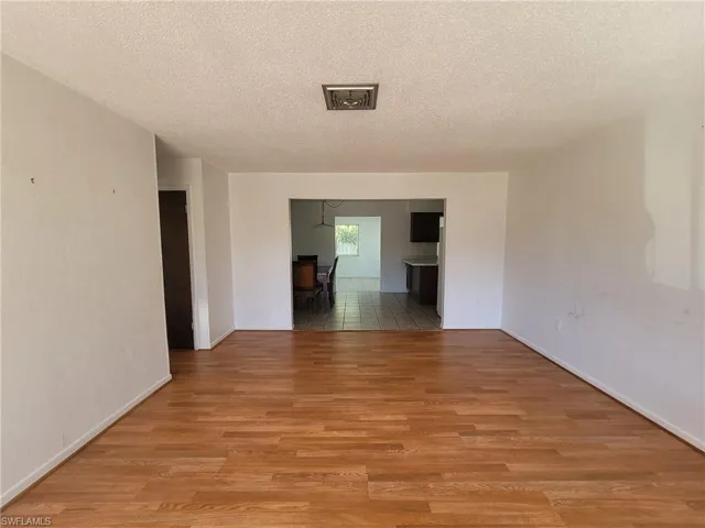 Spare room featuring a textured ceiling and light wood-style flooring
