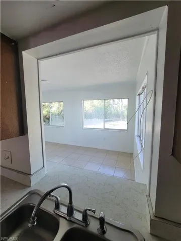 Kitchen featuring a textured ceiling and light tile patterned floors