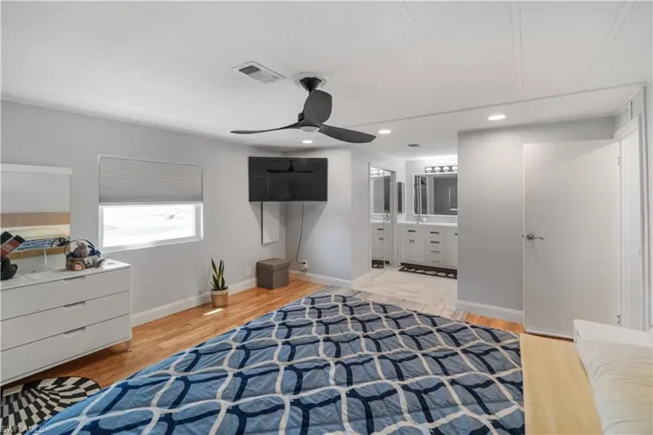 Bedroom featuring wood-finish flooring, a ceiling fan, and recessed lighting
