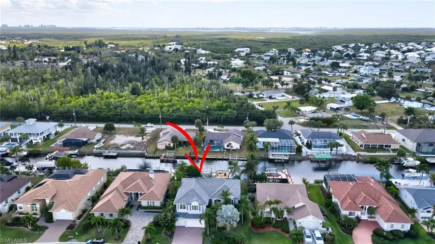 Aerial view of residential area featuring a large body of water