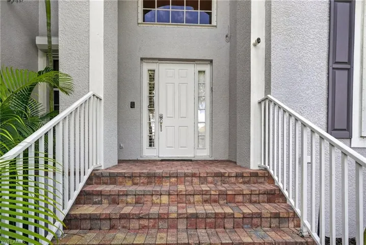 Doorway to property with stucco siding