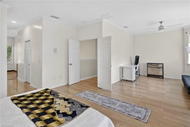 Bedroom featuring crown molding, light wood finished floors, ceiling fan, and recessed lighting